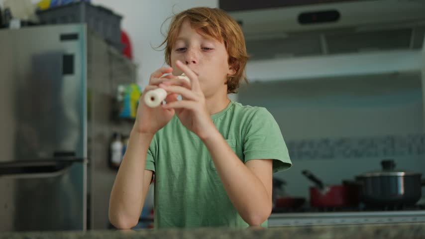 A little boy learns to play the flute at home, practicing with focus and enthusiasm in a cozy, warm setting. A charming scene of early musical exploration, creativity, and childhood growth.