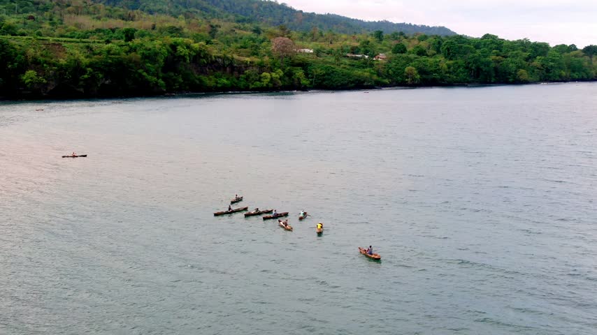 Aerial shot of fishermen on the coast of Neves, on the island of São Tomé and Príncipe.