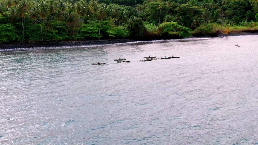Aerial shot of fishermen on the coast of Neves, on the island of São Tomé and Príncipe.
