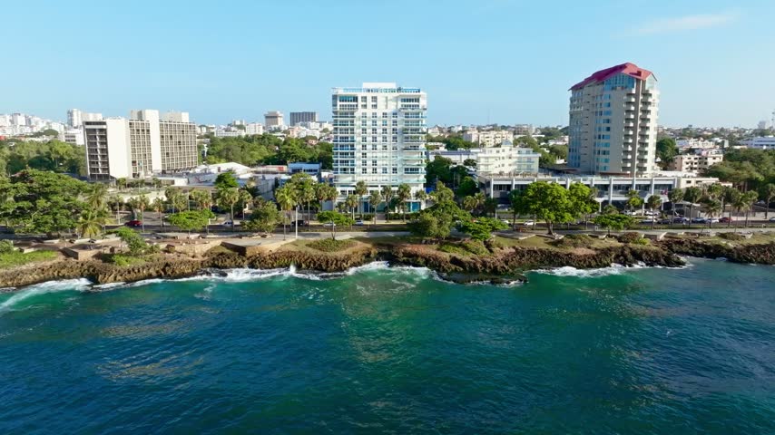 A sunny cityscape of a tropical city on the rocky coast of the Caribbean Sea. A view of the seaside city of Santo Domingo on a sunny summer morning. The capital of the Dominican Republic.