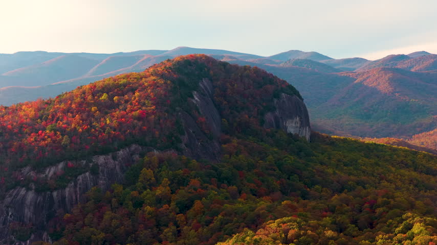 Looking Glass Rock is massive granite mountain formation near Blue Ridge Parkway, Asheville and Brevard. Pisgah National Forest in fall season.