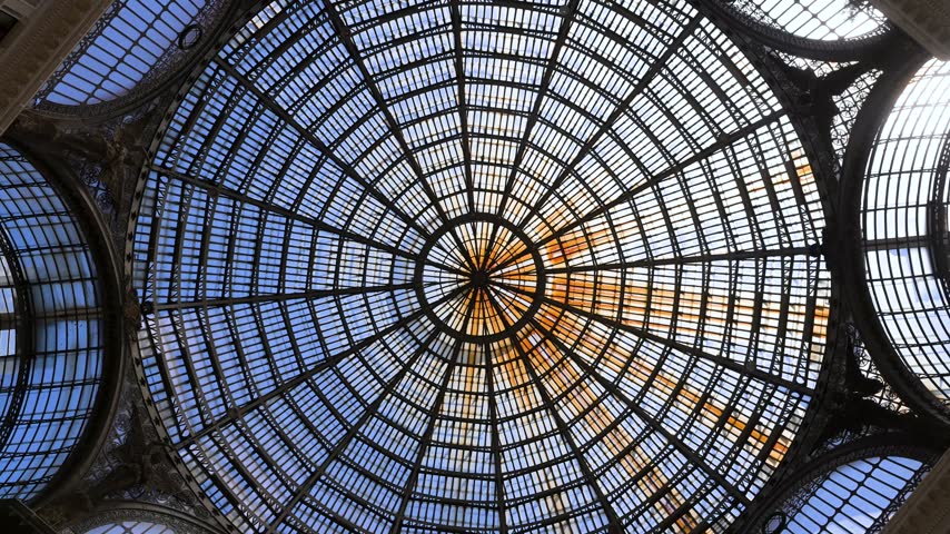 Glass and iron dome of Galleria Umberto I forms a perfect radial pattern as the camera looks straight up inside the historic arcade.