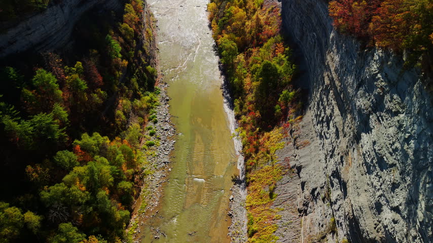 An overhead view shows an autumn river gorge with steep rocky cliffs at Letchworth State Park in New York, America.