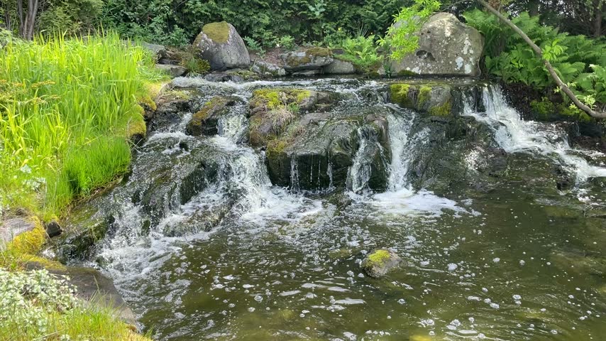 Beautiful small waterfall running down rocks