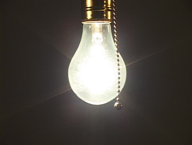 Close up of tungsten light bulb being turned off to with soft ambient light