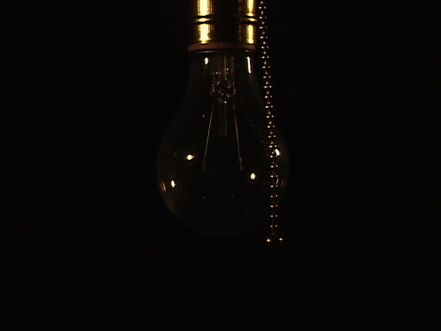 Close up of tungsten light bulb being turned on