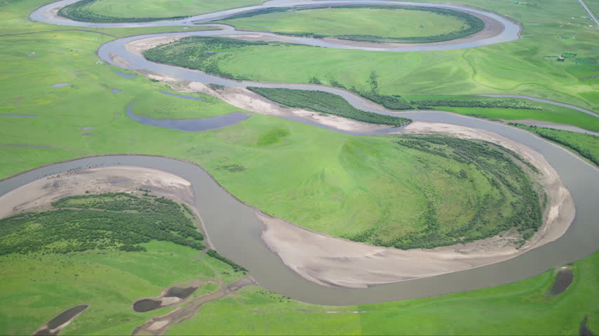 Aba, Sichuan, China - 17th July 2026 - High-Angle Aerial Close-Up View of Meandering Baihe River in Zoige Grassland: Yellow River Upper Reaches, Winding Stream, Shoals, Earth Texture and Green Meadow Background