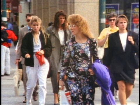 WINNIPEG, MANITOBA - CANADA - CIRCA - 1990: Crowd of people on sidewalk, Winnipeg, Manitoba, Canada, shot in 1990