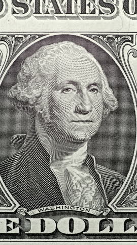 George Washington bill under green security scan. Moving green light sweeps across George Washington bill, causing banknote glow. Anti counterfeit effect exposes layered portrait details on U.S. currency with clear contrast.