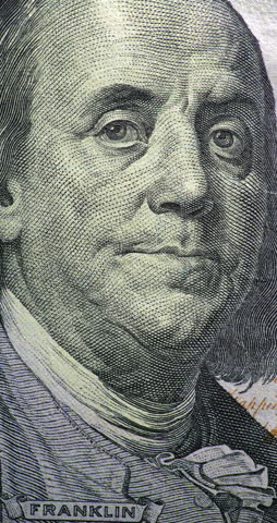 Changing 100 dollar bill with Franklin portrait stop motion. Benjamin Franklin portrait shifts across changing 100 dollar bill views in stop motion.