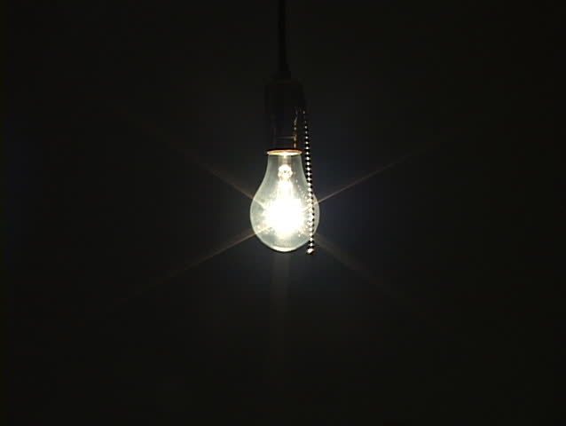 Wide shot of light bulb being turned off to black