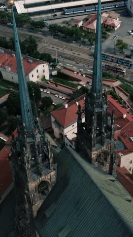 High angle aerial shot of the Cathedral of Saints Peter and Paul spires with the cityscape in Brno, Czech Republic.