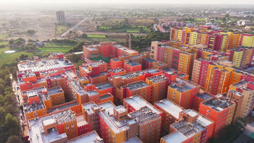 Colorful red and orange residential apartment blocks in India aerial housing complex