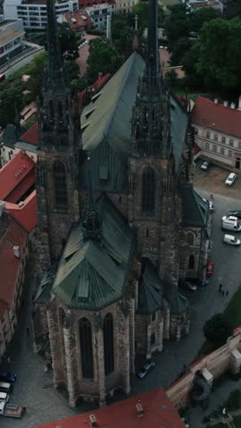 An aerial shot showcases the Gothic Cathedral of St. Peter and Paul amidst historical architecture in Brno, Czech Republic.