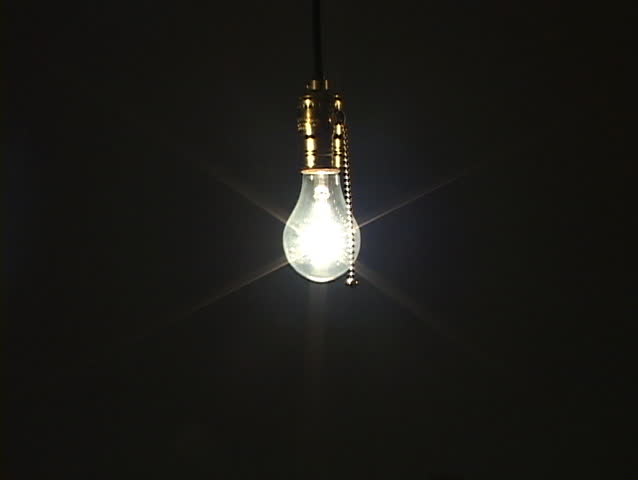 Wide shot of light bulb with soft ambient light being turned off