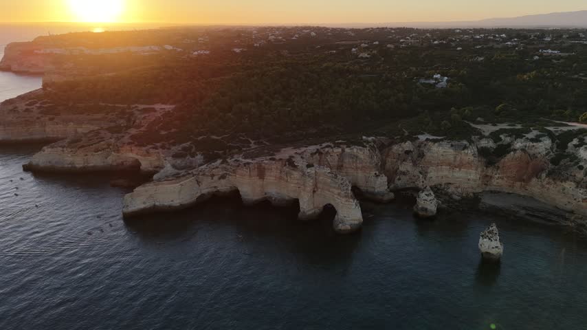 Sunset over stunning cliffs and arches Algarve, Portugal 