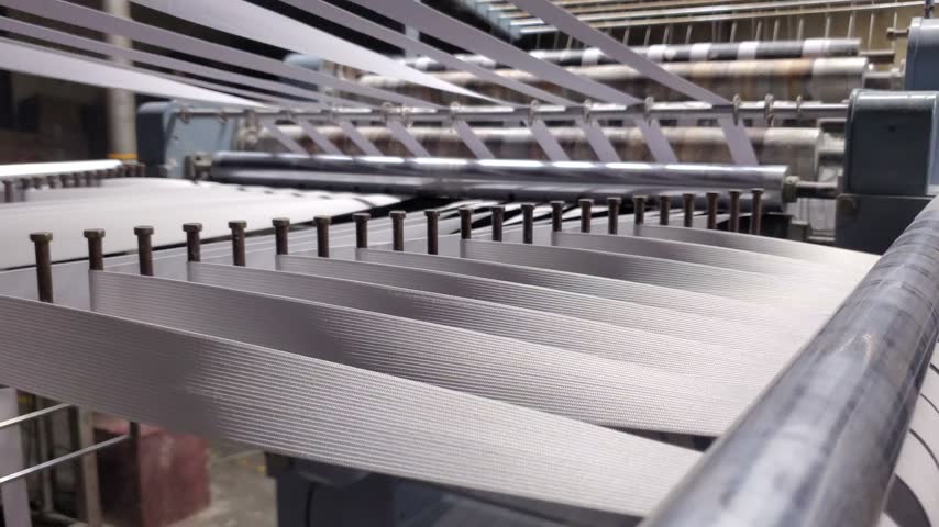 White Elastic Bands Manufacturing On Industrial Loom Machine In Textile Factory

Description:
Close up of white woven elastic tapes moving through an industrial narrow fabric loom machine in a textile factory. Elastic band production for garment manufacturing.