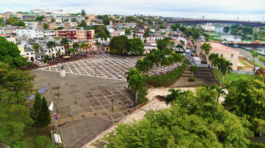 View of the old historic center of Santo Domingo. A Dominican city square. Historic architecture and beautiful nature surround the area. Tourist attraction, drone view.