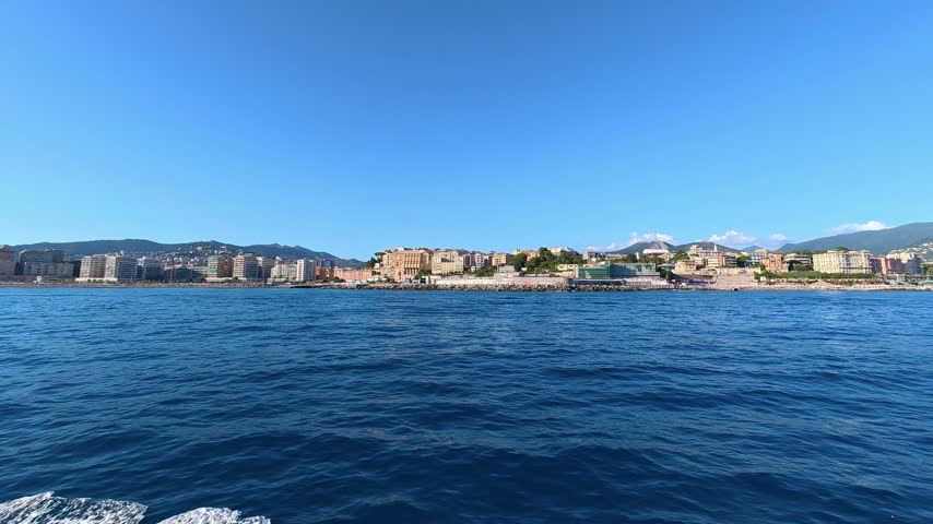 Coastal town skyline seen from the sea. Genoa, Italy.