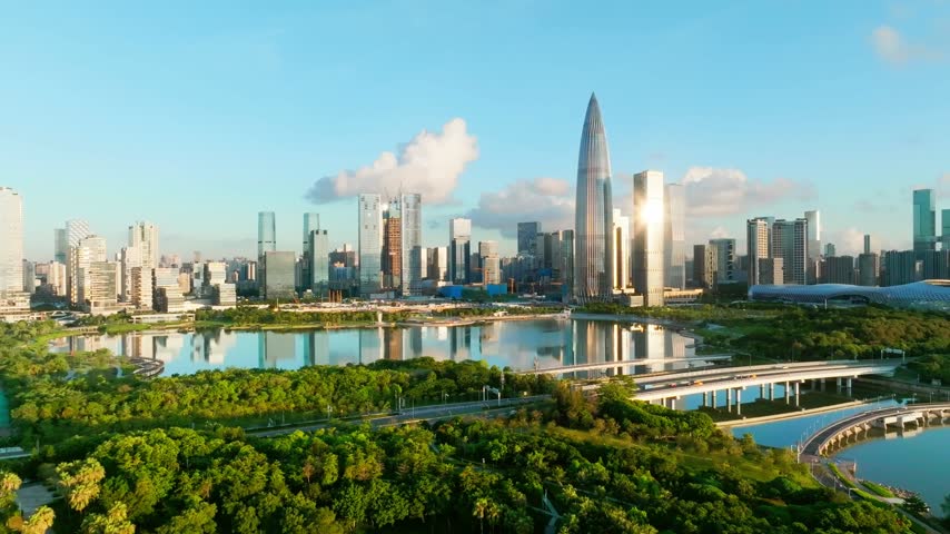 Aerial view of waterfront high rises above parallel footbridges in Shenzhen, Guangdong, China. The scene features China Resources Tower. Relevant to architecture and urban planning.