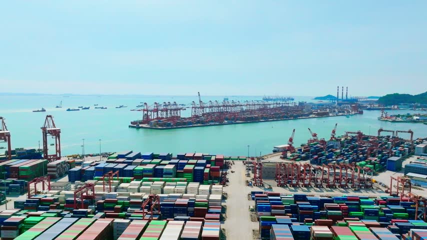 Aerial view of harbor waterway between two container terminals in Shenzhen, Guangdong, China. The scene features Shekou Port. Relevant to maritime logistics and trade infrastructure.