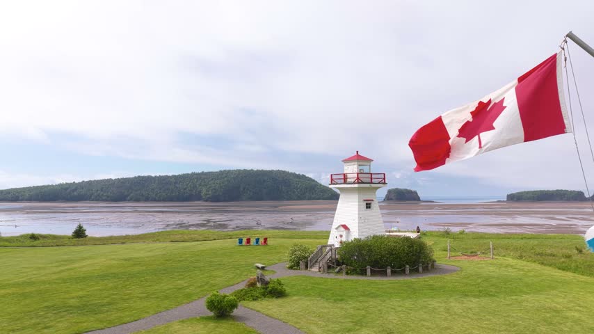 Canadian Flag Waving by Five Islands Lighthouse in Nova Scotia
