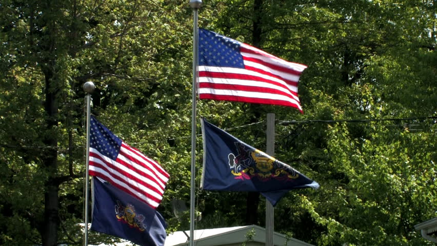 American and Pennsylvania flags blow in the wind.