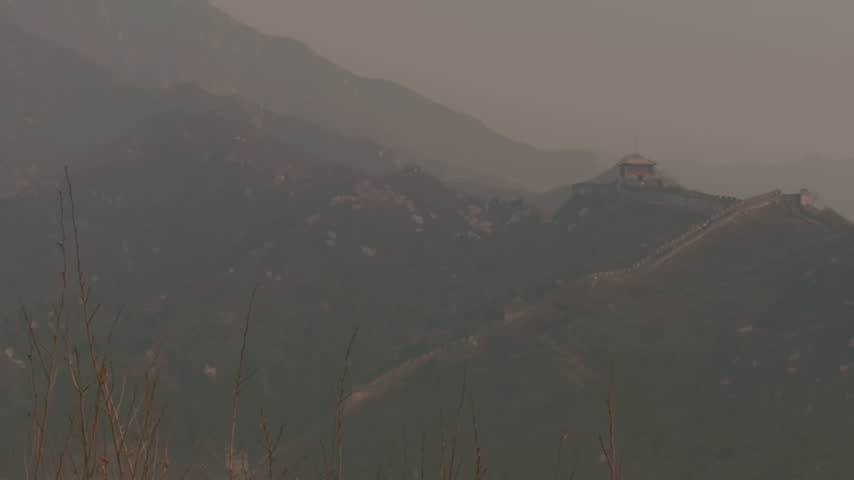 Distant mountain scenery and sections of the Great Wall of China visible through atmospheric haze near Beijing.