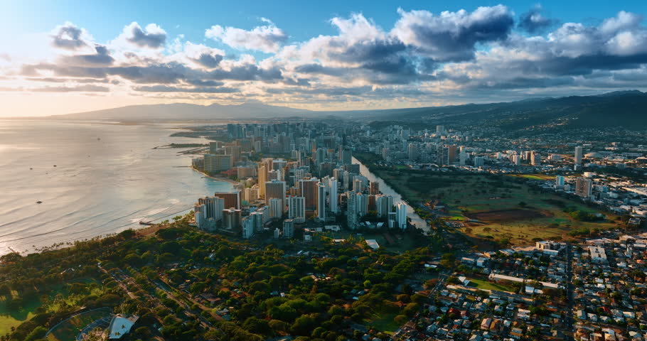 Spectacular scenery of Honolulu, Hawaii, USA at sunset. Grey cumulus clouds gather over the panorama of the city.