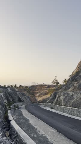 Cyclist Riding on a Scenic Mountain Road