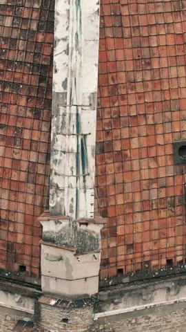 Drone shot starting on the terracotta dome of Santa Maria del Fiore and tilting up to reveal Florence, Italy.
