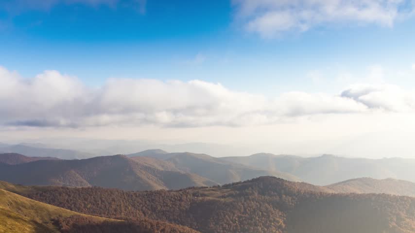 Landscape of hills forestry slopes under sky with clouds