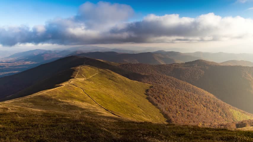 Landscape of hills forestry slopes under sky with clouds