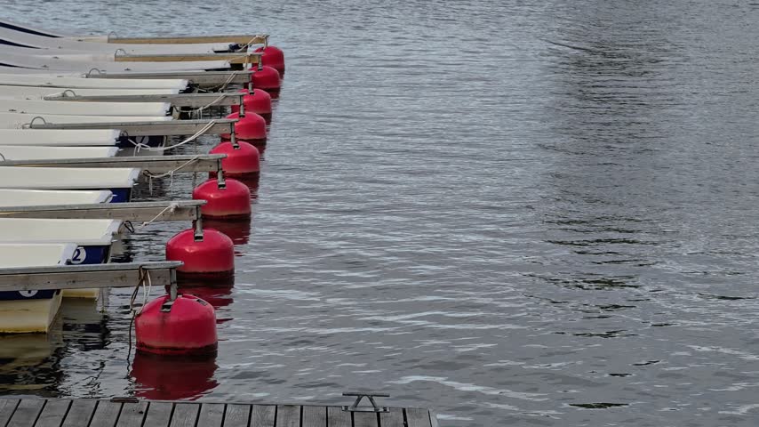 Boats tied to a dock, a scenic waterfront scene.