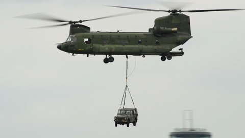 A Chinook CH-47 helicopter carries a car on the hook. 10973 

