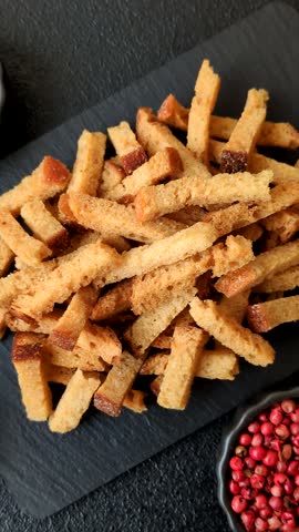 Croutons or crackers made from rye bread with garlic, salt, and spices. Croutons with salt