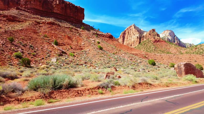 Scenic winding road curves through the panoramic rock rim formations of Zion National Park