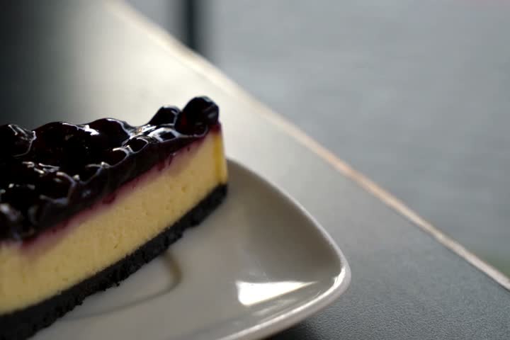 Blueberry Cheesecake Slice On White Plate