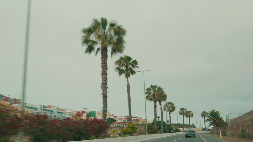 First person view from moving car of city and asphalt road of Gran Canaria. Cityscape of Las Palmas, through the eyes of car driver