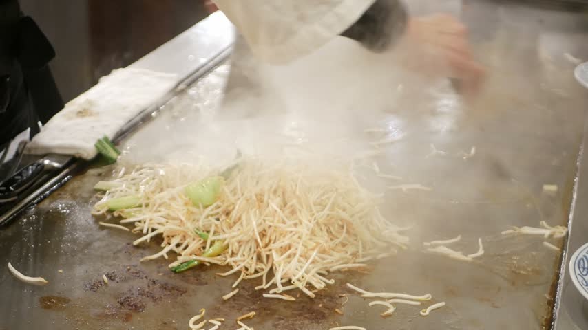 POV motion while chef is cooking stir fried bean sprout of Yasai Itame fried vegetable in japanese style,japanese style sidedish for kobe beef steak meal