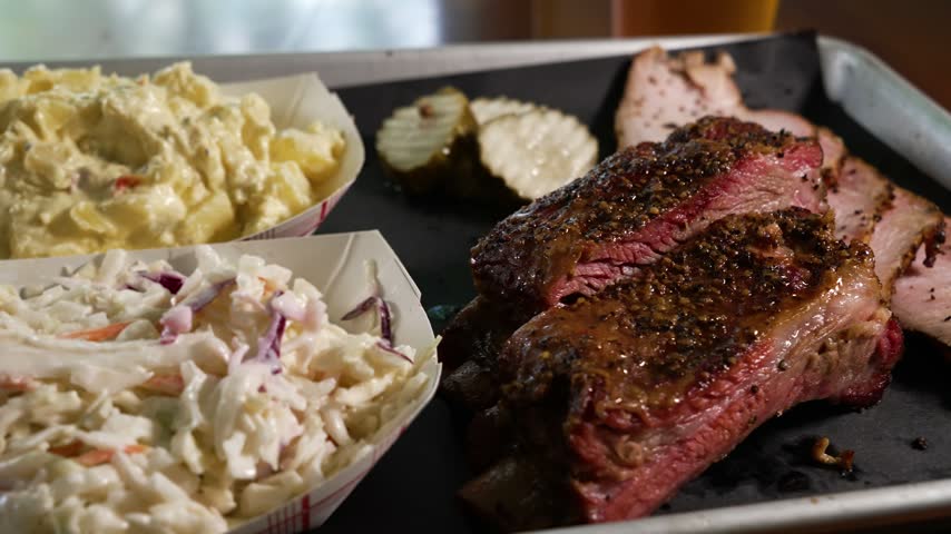 Traditional Texas two meat barbecue plate featuring smoked turkey, tender beef ribs, creamy coleslaw, potato salad, pickles, close up, slider, 4K