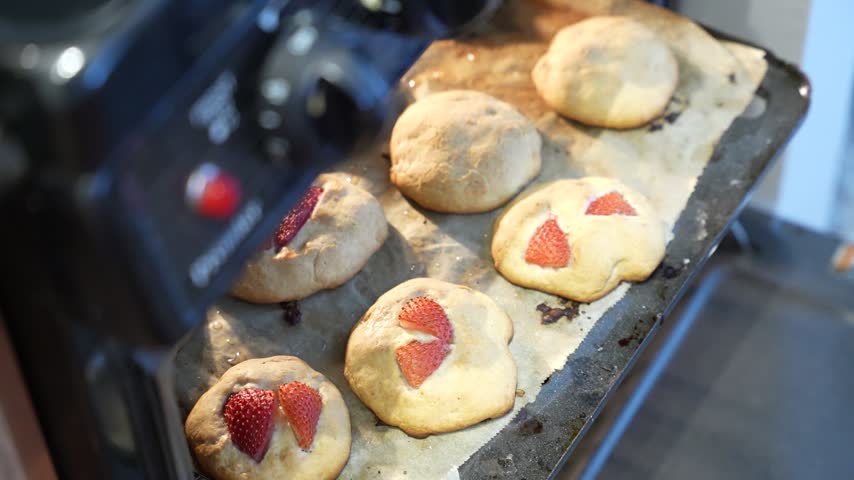 A failed batch of homemade strawberry cookies in the open oven, imperfect baking attempt horizontal video