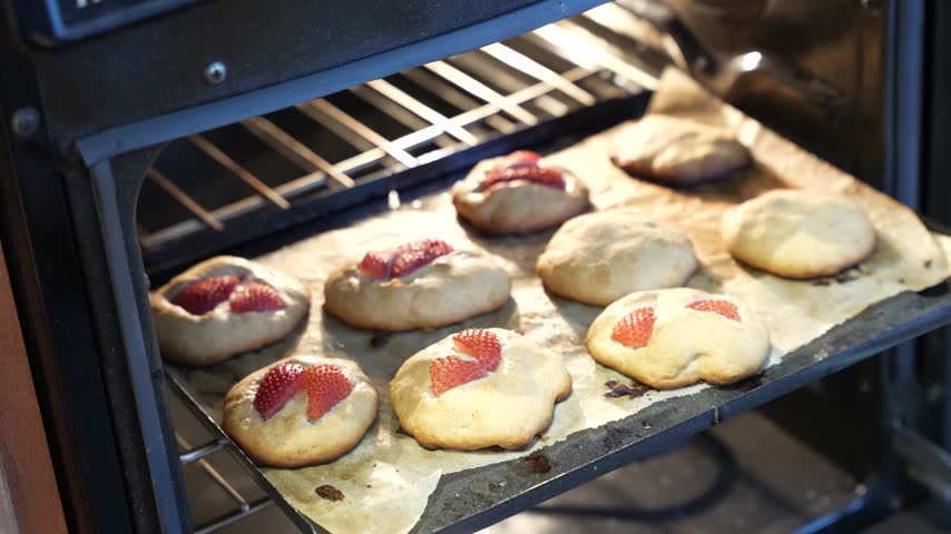 Open oven with homemade strawberry cookies gone slightly wrong, real, imperfect home baking moment video