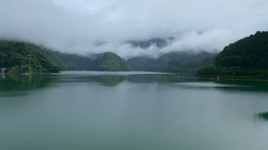 A view of Lake Okutama and the surrounding mountains shrouded in clouds