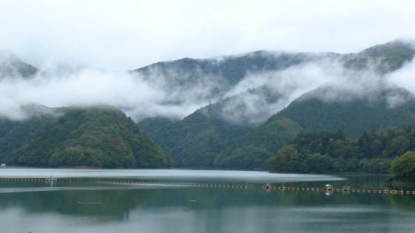 A view of Lake Okutama and the surrounding mountains shrouded in clouds