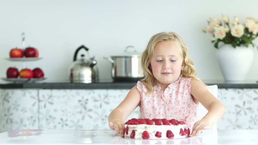 Lovely girl going to eat strawberry cake
