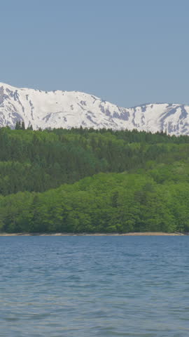 Blue Lake Below Snow Capped Mountain Vertical Video