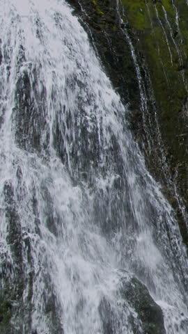 Falling Water Over Dark Wet Rock Close Up Vertical Video