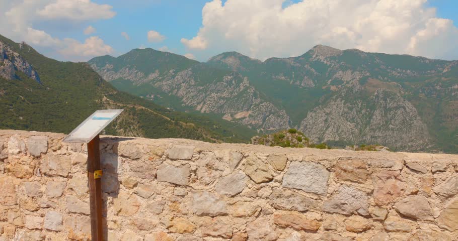 A scenic viewpoint overlooking the Alpes-Maritimes, or Alps of the Sea, in southern France, with rugged mountains, green hills and the surrounding landscape visible