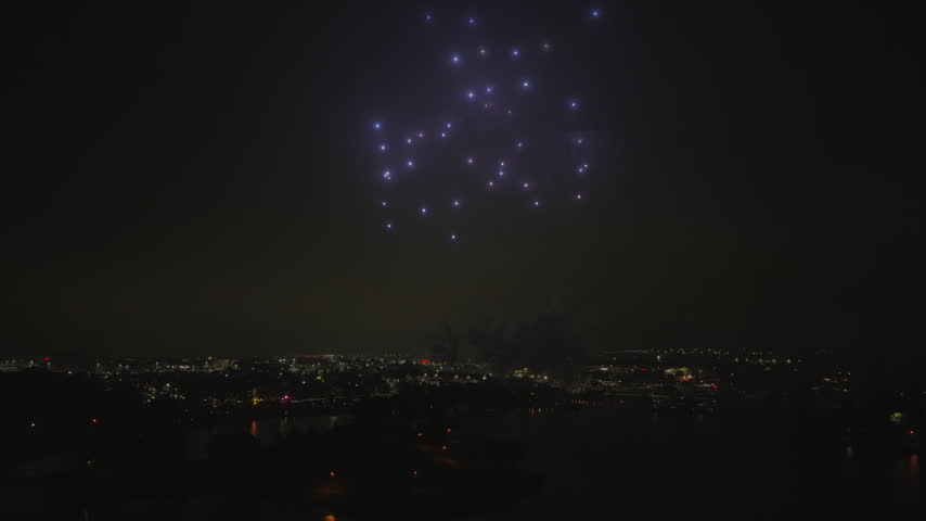 4 July night: fireworks over a lakeside park with crowds along the water. Destination footage for Chicago-area suburbs travel guides and summer event promotion.